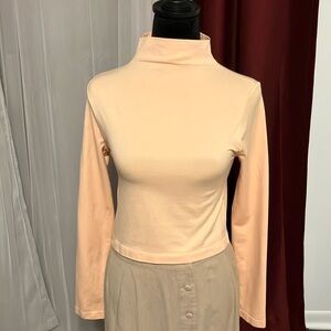 This melon colored long sleeved blouse is perfect for the fall weather.